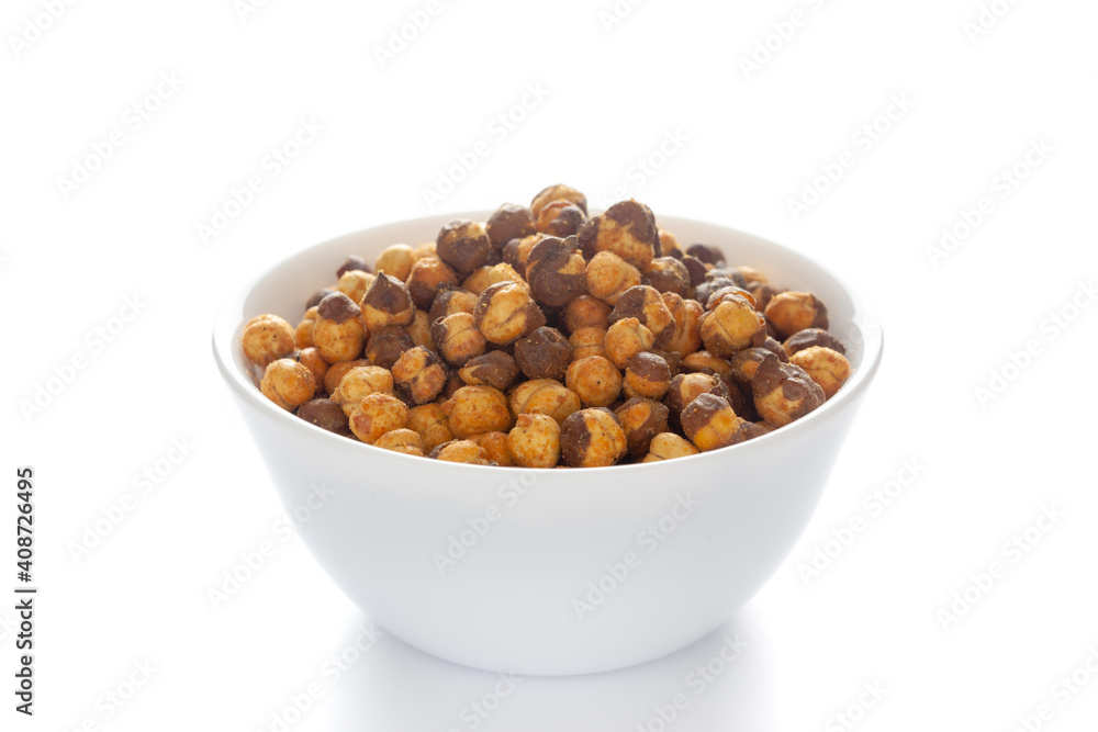Crunchy Roasted Chana Masala in a white bowl, made with Bengal Grams or Chickpeas. Pile of Indian spicy snacks (Namkeen). Side view, against the white background Crunchy Roasted Chana Masala in a white bowl, made with Bengal Grams or Chickpeas. Pile of Indian spicy snacks (Namkeen). Side view, against the white background