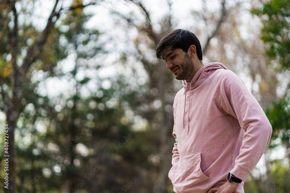 tall young man against background of trees tall young man against background of trees