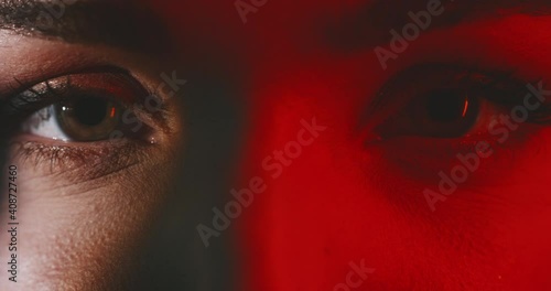 Close up of woman's beautiful eyes with red light