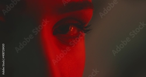 Close up of woman's beautiful eyes with red light