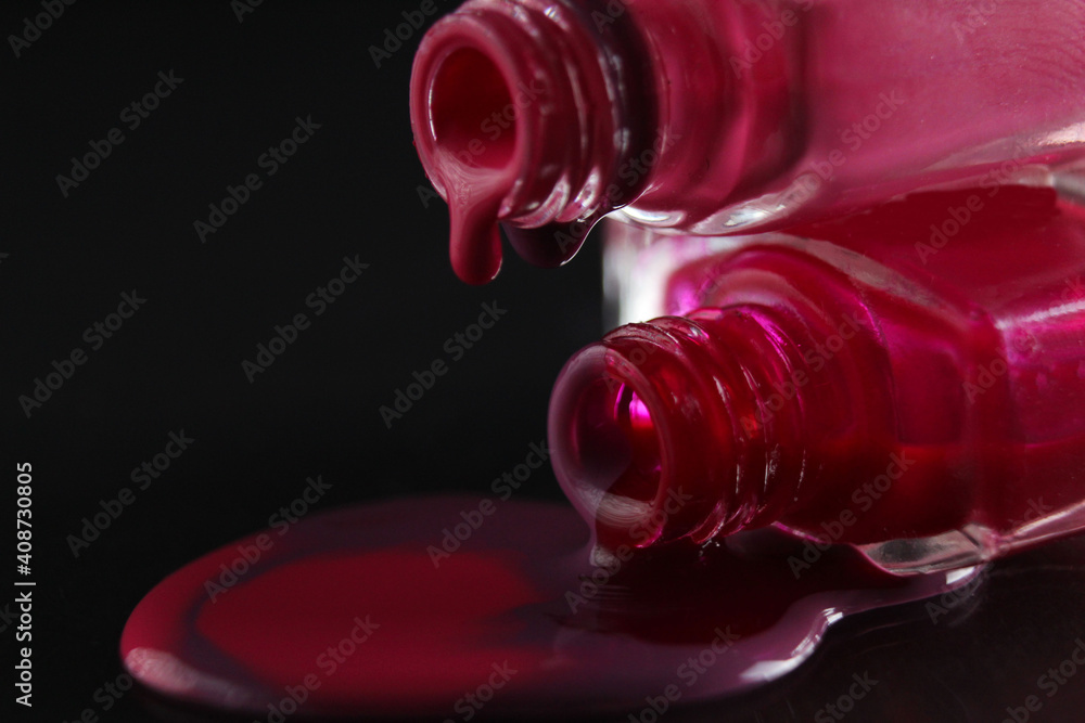 flowing drops of nail polish red purple burgundy macro plan on a shadowy black background flowing drops of nail polish red purple burgundy macro plan on a shadowy black background