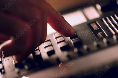 Close-up of a man's hand dialing a phone