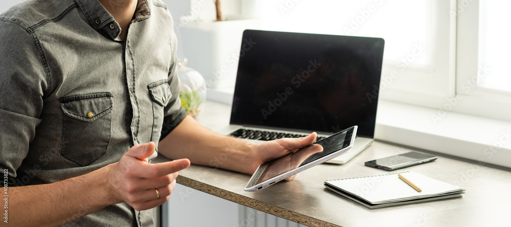 Smiling young man freelancer using laptop, studying online, working from home, happy casual guy typing on pc notebook surfing internet, enjoying distant job, sit at table. - obrazy, fototapety, plakaty 