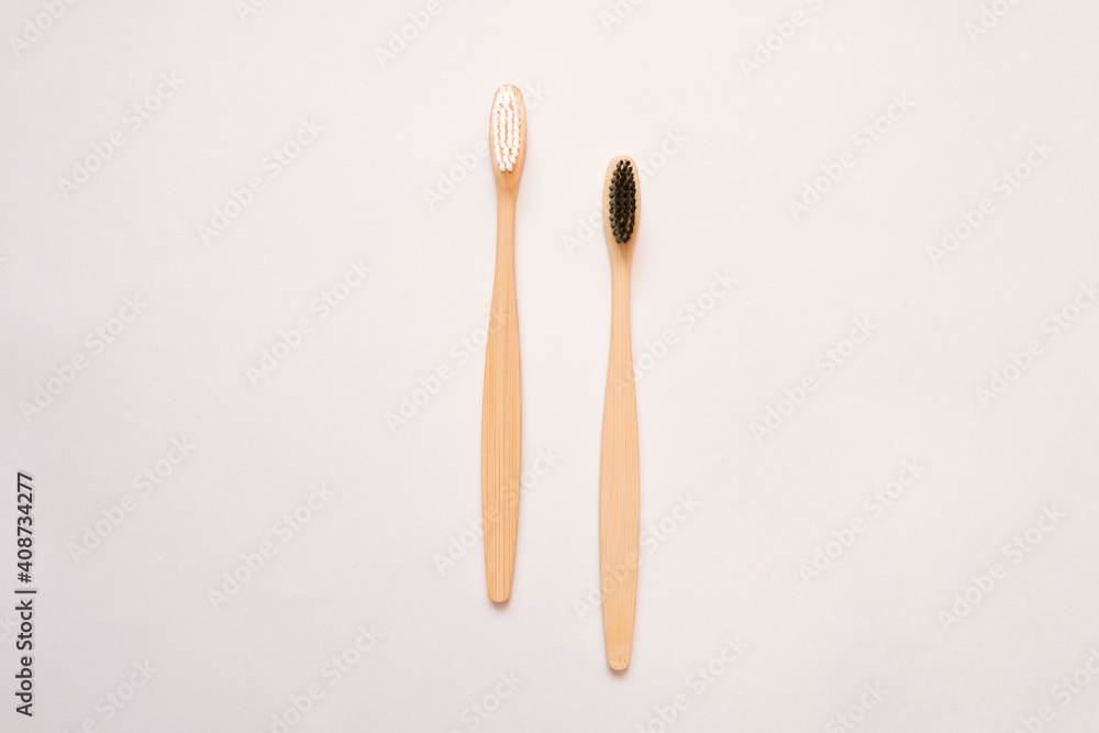 Bamboo toothbrushes with white and black bristles on white. Eco friendly toothbrush concept. copy space for text Bamboo toothbrushes with white and black bristles on white. Eco friendly toothbrush concept. copy space for text