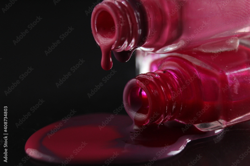 flowing drops of nail polish red purple burgundy macro plan on a shadowy black background flowing drops of nail polish red purple burgundy macro plan on a shadowy black background