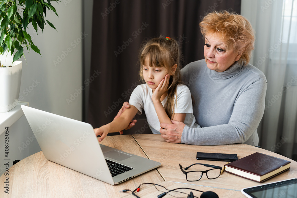 modern grandmother teaching grandchild how to use laptop computer at home modern grandmother teaching grandchild how to use laptop computer at home