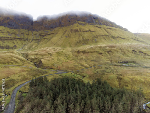 Aerial view on a small road by forest and mountains . Gleniff Horseshoe drive in county Sligo, Ireland, Peak in a cloud. Nobody. photo