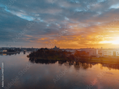 Beautiful sunset over Galway city, Ireland, Corrib river, Blue and orange color cloudy sky. Aerial view. Calm and peaceful atmosphere © mark_gusev