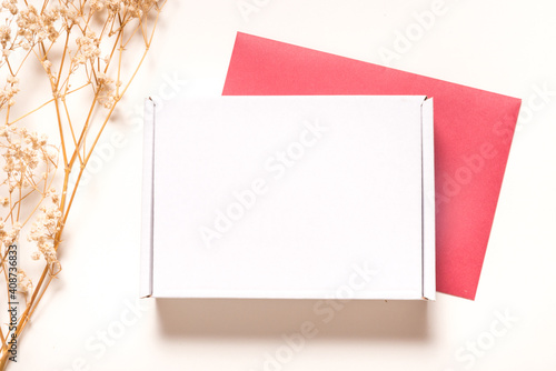 White Carton box decorated with dried grass