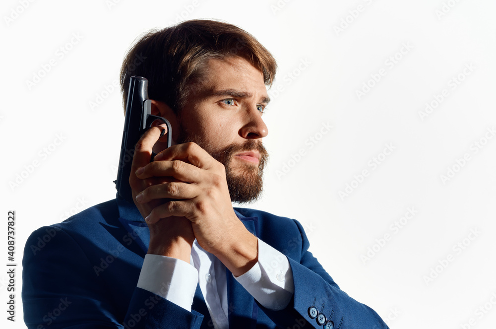business man in a suit with a gun in his hands detective caution crime business man in a suit with a gun in his hands detective caution crime
