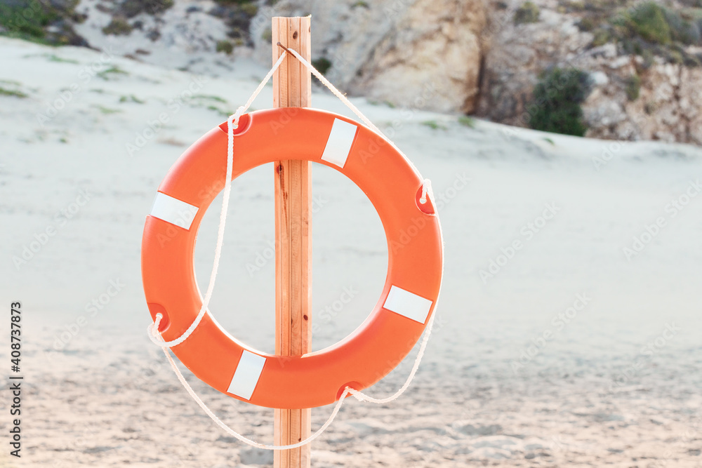 lifebuoy on the beach at the resort. Concept of vacation and safety when swimming in the sea