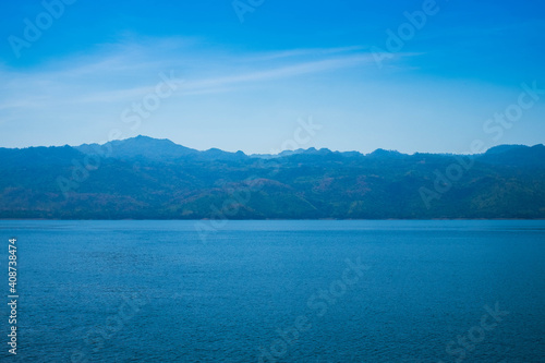 Beautiful scenery view of blue sky mountain lake. Summer, landscape nature of green tree and rock in forest tranquility. Nature tourism and parks outdoor concept