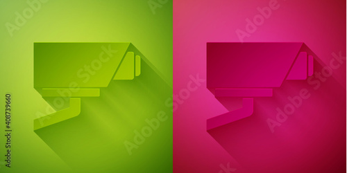 Paper cut Security camera icon isolated on green and pink background. Paper art style. Vector.