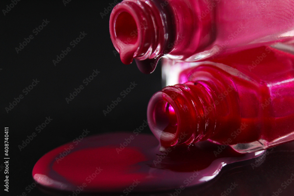 flowing drops of nail polish red purple burgundy macro plan on a shadowy black background flowing drops of nail polish red purple burgundy macro plan on a shadowy black background