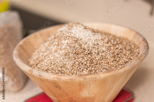 man weighs malt for brewing beer on scale
