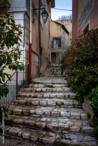 Fototapeta Naklejka Na Ścianę i Meble -  street scene with stairs leading into village ,Fontaine de Vaucluse , Provence ,france .