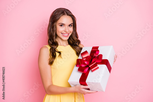 Photo of charming wavy hairdo cheerful lady hands hold giftbox toothy smile isolated on pink color background © deagreez