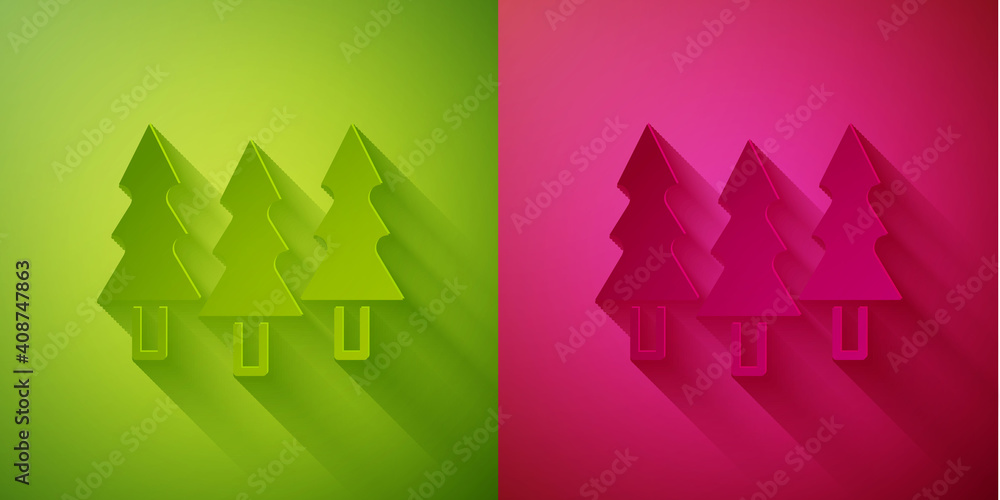 Fototapeta premium Paper cut Trees icon isolated on green and pink background. Forest symbol. Paper art style. Vector.
