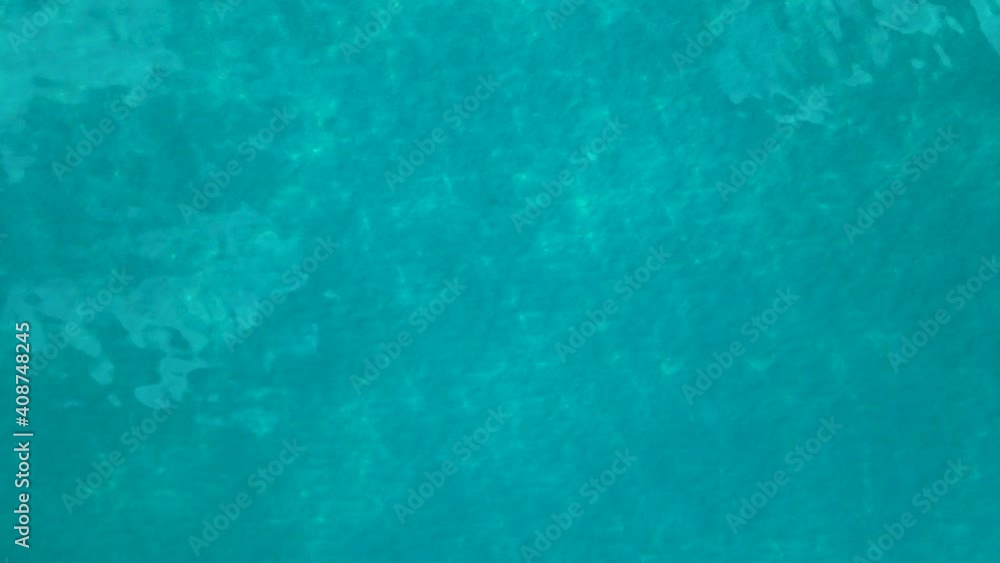 Sea water surface video background for beach vacation holidays projects. 4k aerial footage from drone of peaceful waves with sunlight effects, relaxing pattern texture Sea water surface video background for beach vacation holidays projects. 4k aerial footage from drone of peaceful waves with sunlight effects, relaxing pattern texture