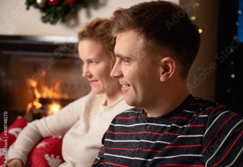 Christmas Couple at home by the fireplace