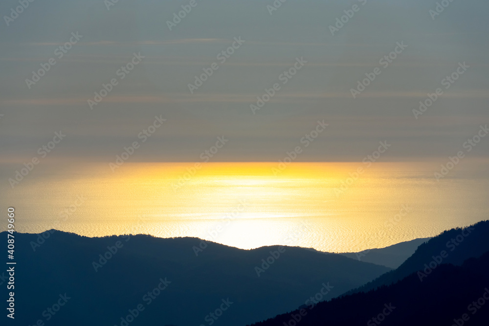 sunset in the mountains over the sea