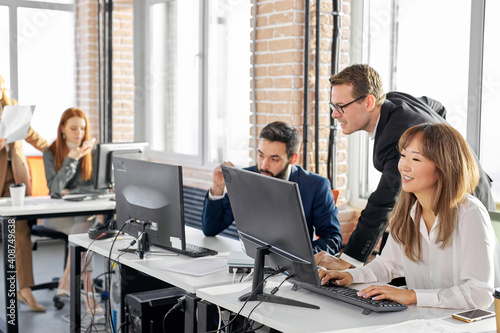 multi-ethnic business workers working together with smile on face in modern office, young men and women in formal wear have conversation