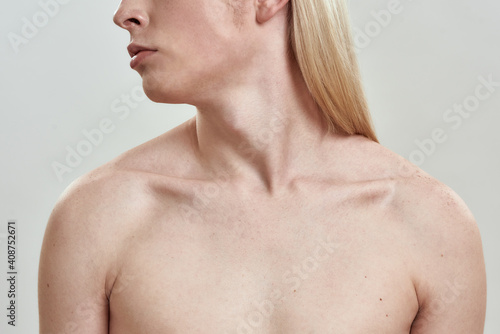 Collarbone of young slim long haired naked male model