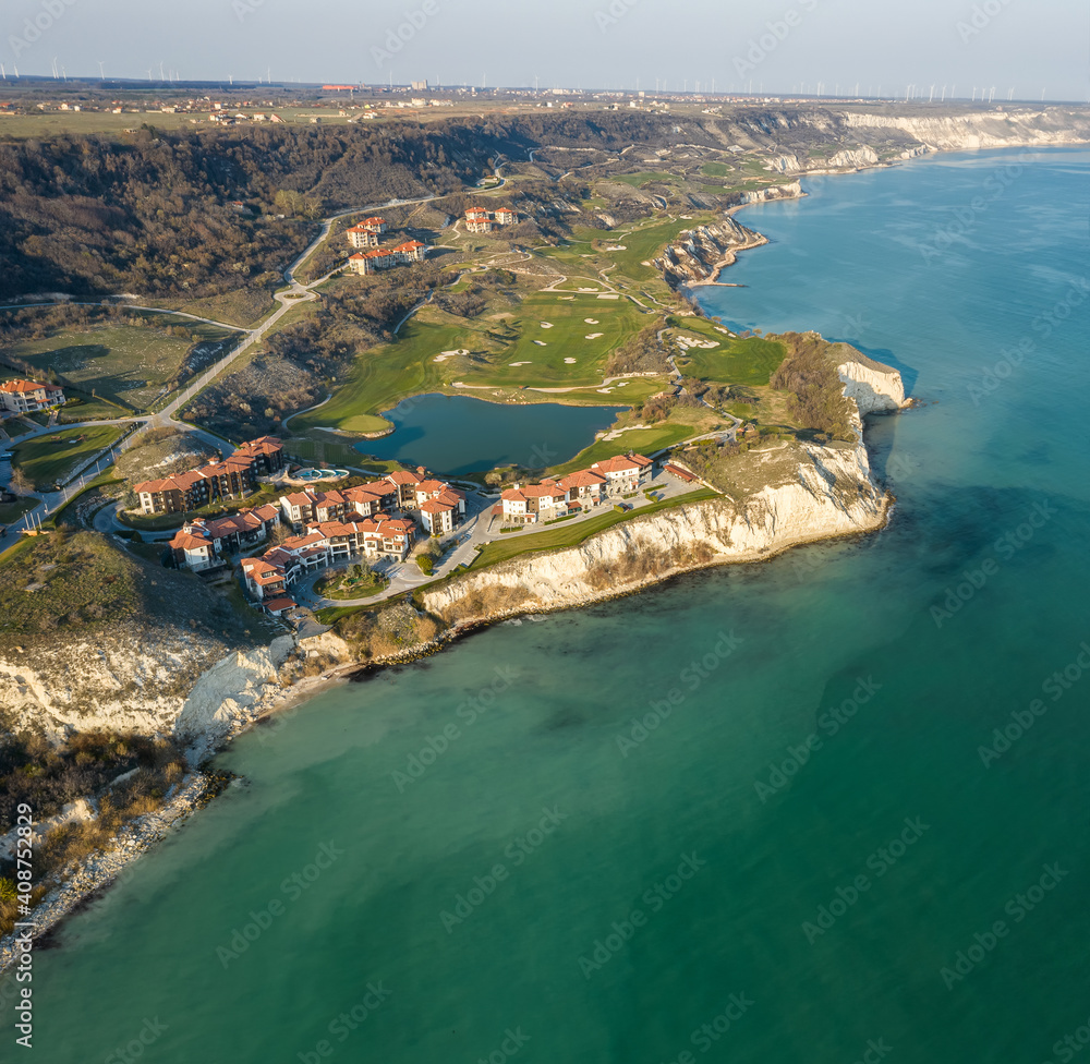 Panoramic view of picturesque landscape with green hills, golf fields and buildings near the rocky coastline of the Black sea, Thracian Cliffs golf and beach resort, Bulgaria