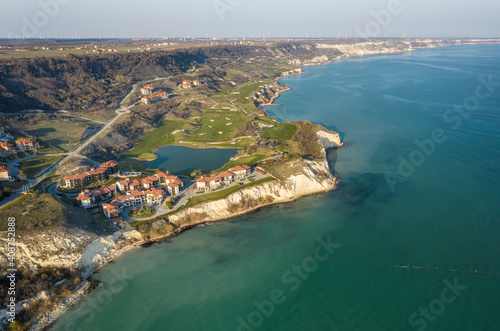 Fototapeta Naklejka Na Ścianę i Meble -  Panoramic view of picturesque landscape with green hills, golf fields and buildings near the rocky coastline of the Black sea, Thracian Cliffs golf and beach resort, Bulgaria