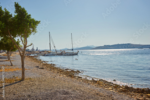 View of Bodrum Beach, Aegean sea, traditional white houses, flowers, marina, sailing boats