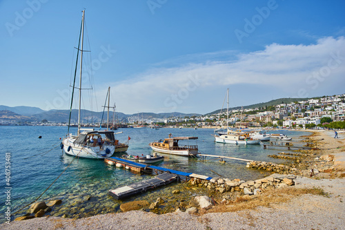 View of Bodrum Beach, Aegean sea, traditional white houses, flowers, marina, sailing boats