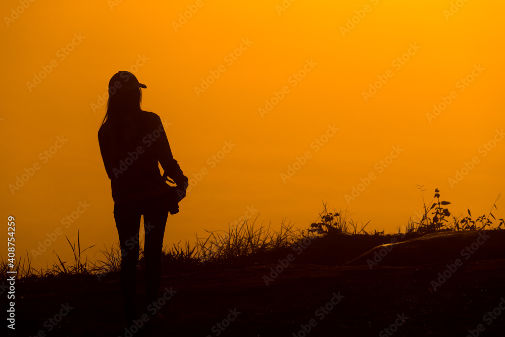 Photographer woman silhouette and sunrise