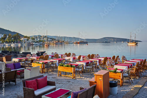 Fototapeta Naklejka Na Ścianę i Meble -  Cute chairs and table on the beach at seaside restaurant in Bodrum