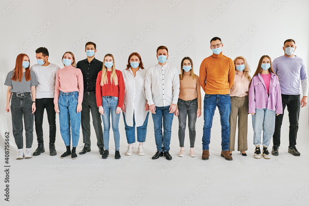 Obraz premium young people in covid 19 times protected with face mask, many men and women stand together in crowd isolated in studio on white background