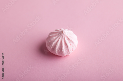 Pink sweet meringue on pastel pink background. Top view.
