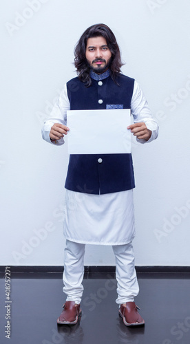 Man standing with black paper in both hands. photo