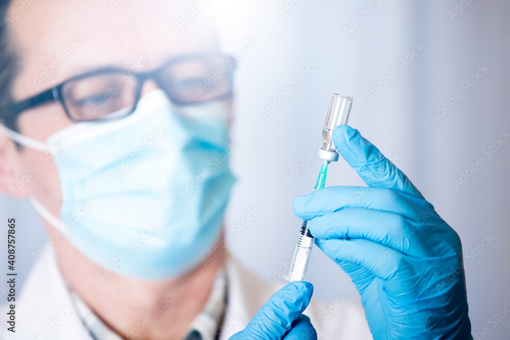 Close up of hands of doctor preparing for vaccination Close up of hands of doctor preparing for vaccination