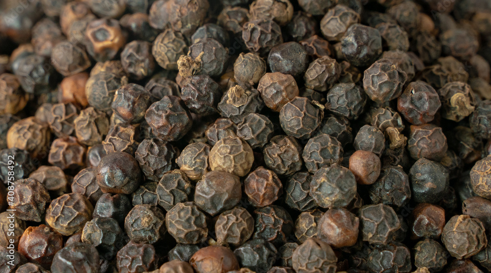 Black pepper grains as background close up. Black pepper grains as background close up.