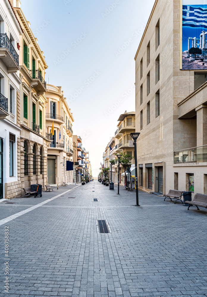 One of the main street of the Heraklion center, 25th of August. Empty street, no people. Sunny morning. Selective focus.