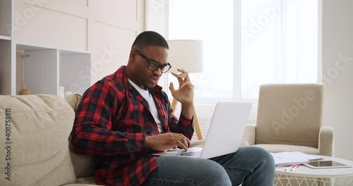 Crazy man celebrating online success using laptop at home