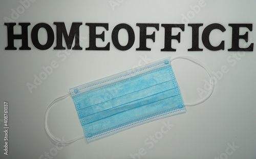 the word home office with a mask in front of a white background   