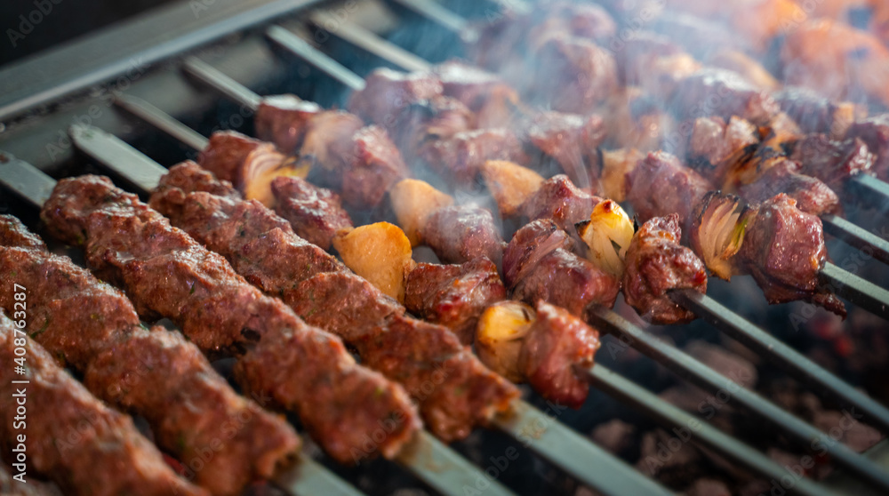 Arabic traditional food , tomato ,kufta, Shish taouk and lamb brochette on the grill. traditional food.