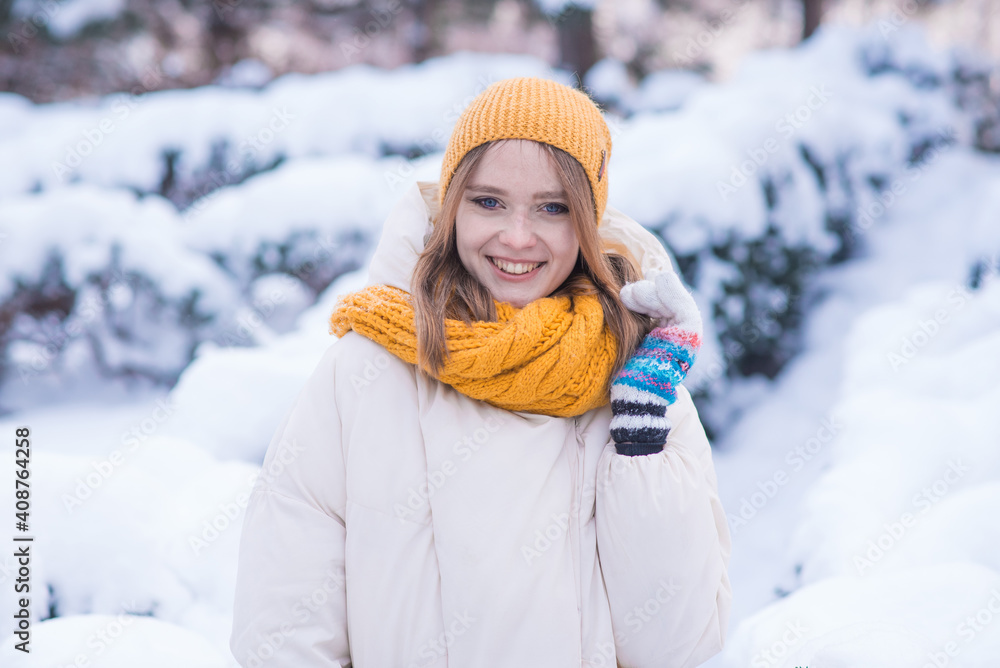 Portrait of a happy smiling girl on a snowy winter day Portrait of a happy smiling girl on a snowy winter day