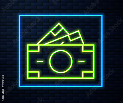 Glowing neon line Stacks paper money cash icon isolated on brick wall background. Money banknotes stacks. Bill currency. Vector.