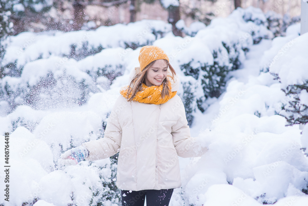 Portrait of a happy smiling girl on a snowy winter day Portrait of a happy smiling girl on a snowy winter day