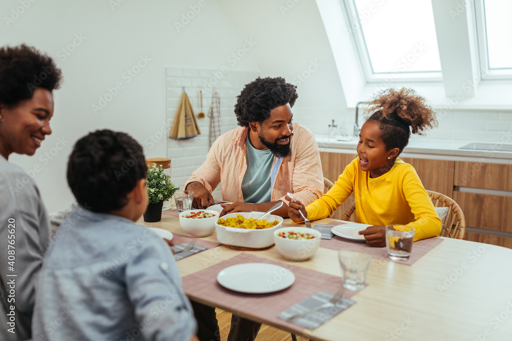 Afro family eating together at home Afro family eating together at home