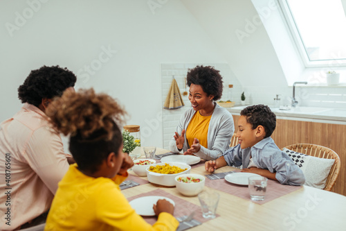 Afro family eating together at home