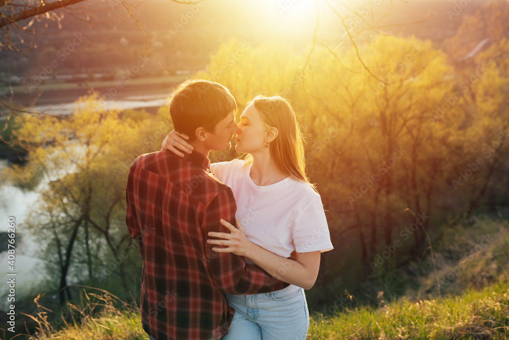 Romantic portrait of stunning couple in love hugs and want to kiss on the hill at sunset. Warm soft colours. Romantic portrait of stunning couple in love hugs and want to kiss on the hill at sunset. Warm soft colours.