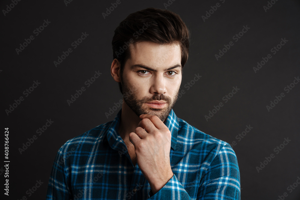 Confident handsome unshaven guy posing and looking at camera Confident handsome unshaven guy posing and looking at camera
