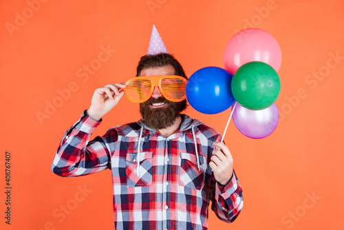 party goer. happy birthday to you. male holiday celebration. bearded guy with party balloons. unshaven brutal man with beard celebrate business success. express pure happiness